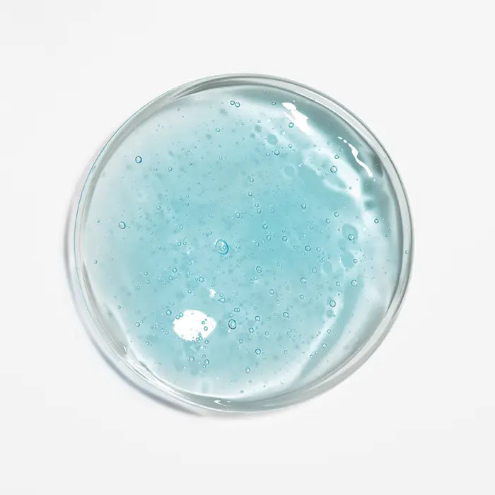 Close-up of blue fluid scalp concentrate texture with bubbles
