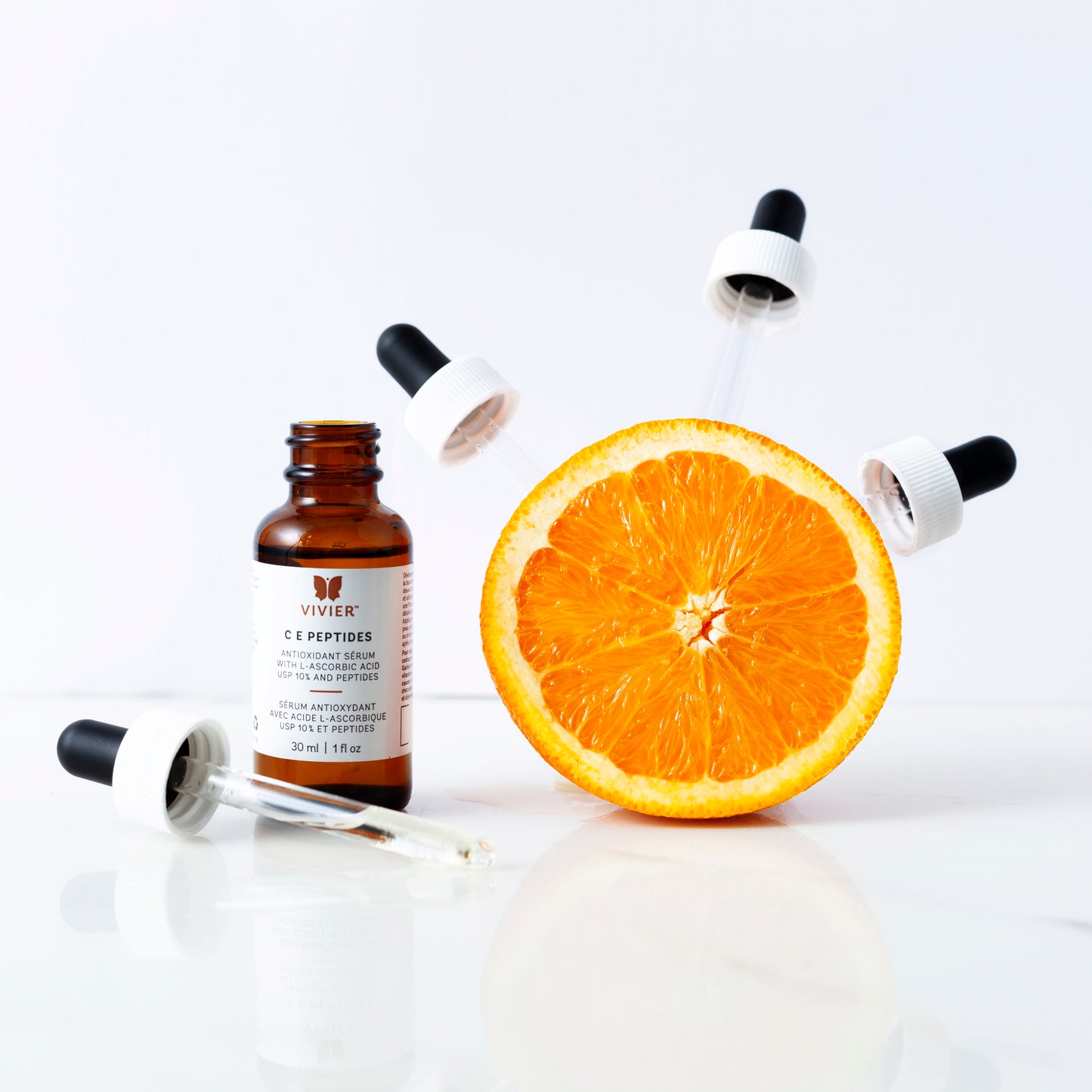 C E Peptides 10% Vitamin C serum by Vivier with orange slice and dropper applicators