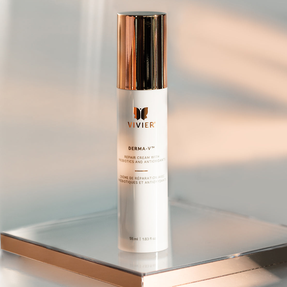 Vivier DERMA-V face cream bottle displayed on a reflective surface with soft lighting, highlighting the packaging design and texture.