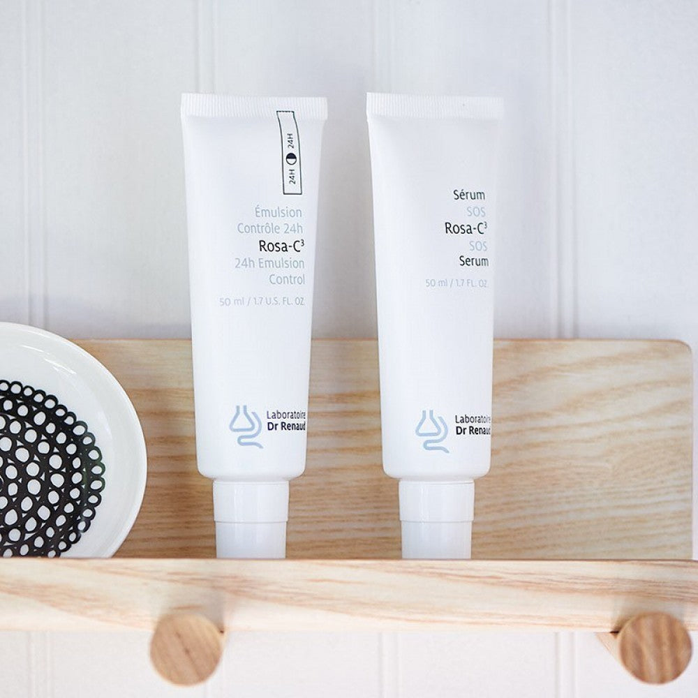 Rosa-C³ 24H Emulsion Control and Rosa-C³ SOS Serum by Laboratoire Dr Renaud displayed together on a wooden shelf.