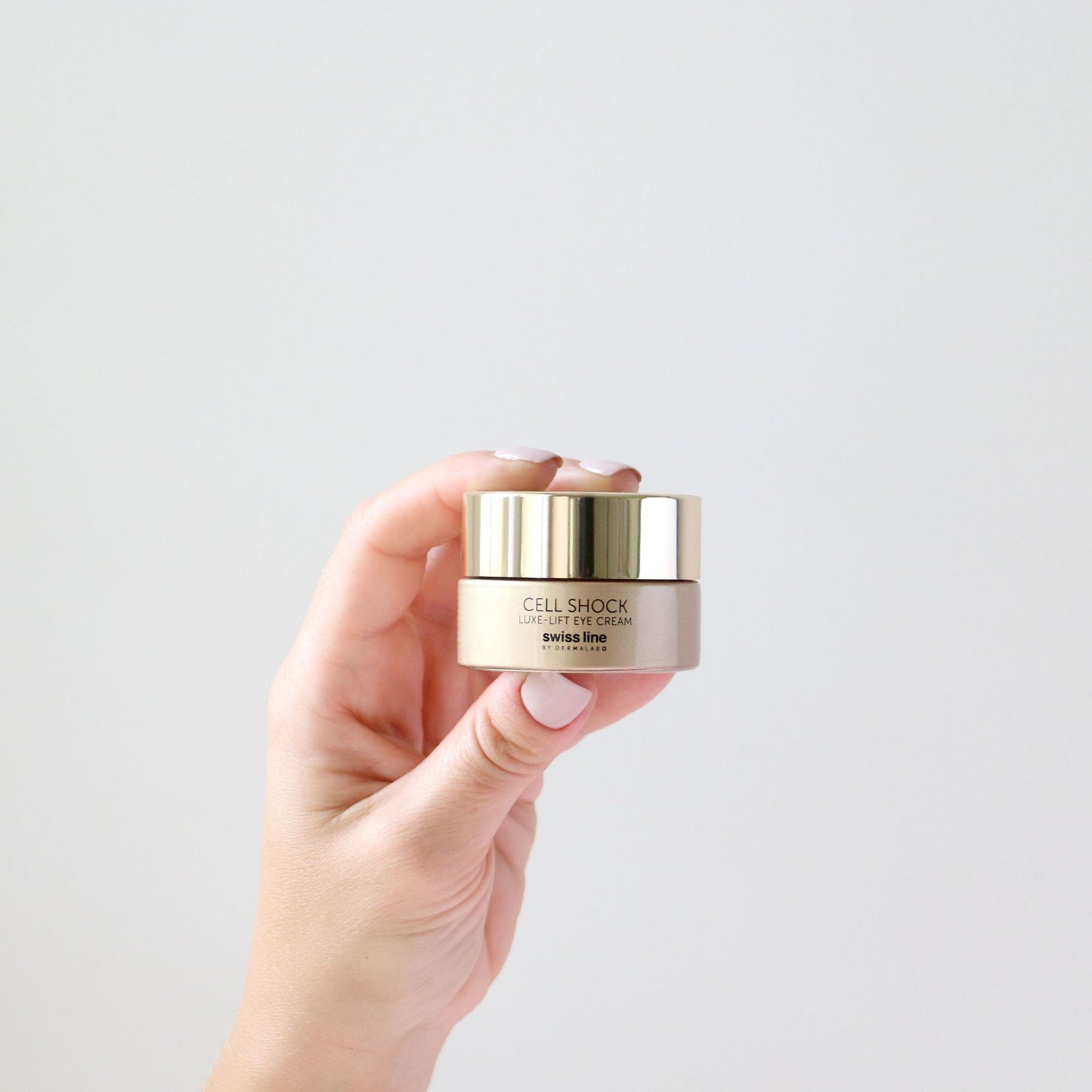 Swissline Luxe-Lift Eye Cream 15 ml jar held in hand